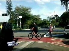 Ciclista levanta carro com as mãos para tirá-lo de cima de ciclovia