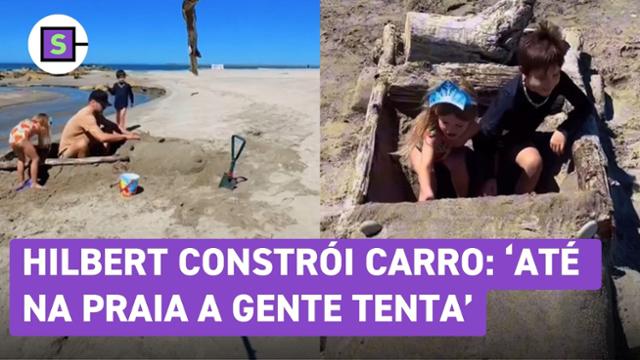 Rodrigo Hilbert constrói carro de areia para a filha na praia